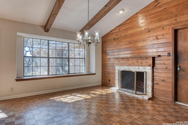 unfurnished living room with lofted ceiling with beams, parquet flooring, a fireplace, and an inviting chandelier