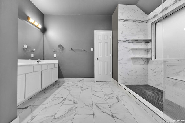 bathroom featuring a tile shower and vanity