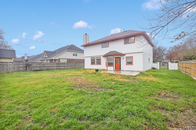 rear view of house featuring a patio and a yard