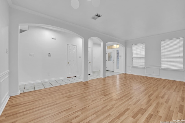 interior space with crown molding and light hardwood / wood-style floors