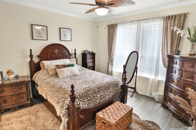 bedroom with crown molding, ceiling fan, and light hardwood / wood-style flooring