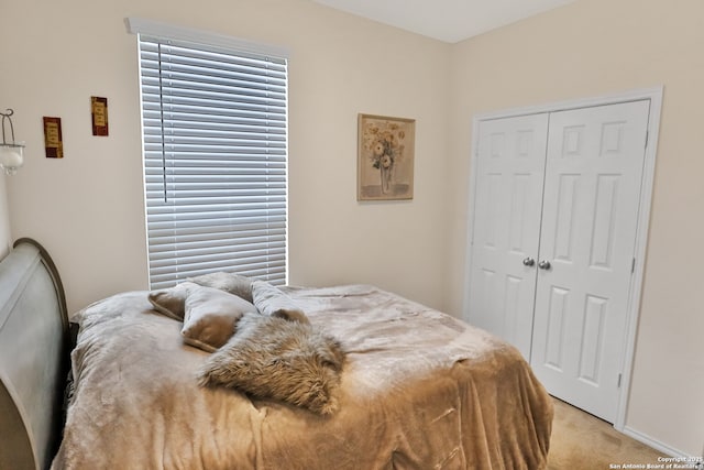 bedroom featuring a closet and light carpet