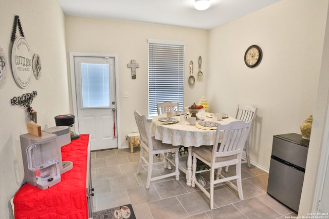 dining space with tile patterned flooring