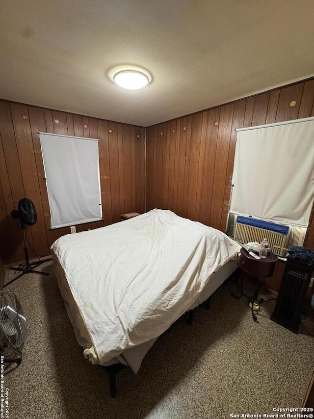 carpeted bedroom with wooden walls