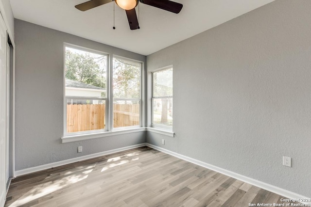 spare room with light hardwood / wood-style flooring and ceiling fan