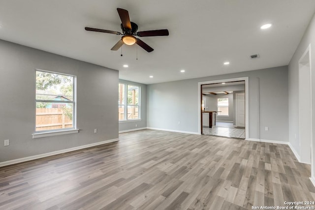 unfurnished living room with ceiling fan and light hardwood / wood-style floors