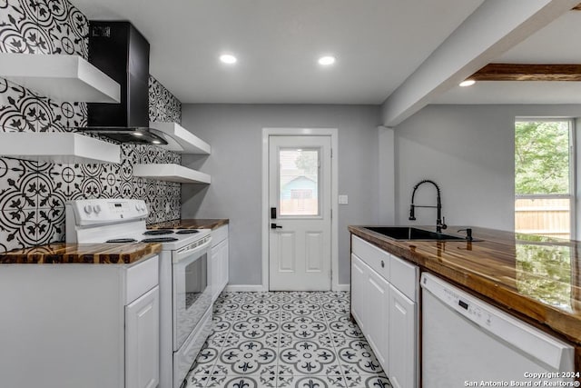 kitchen featuring white cabinets, sink, wooden counters, and white appliances