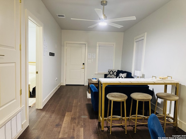 dining area with dark hardwood / wood-style floors and ceiling fan