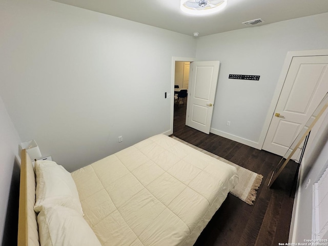 bedroom with dark wood-type flooring