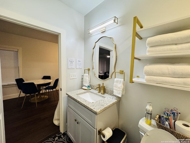 bathroom with vanity, hardwood / wood-style floors, and toilet