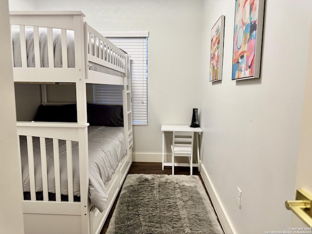 bedroom with dark hardwood / wood-style flooring