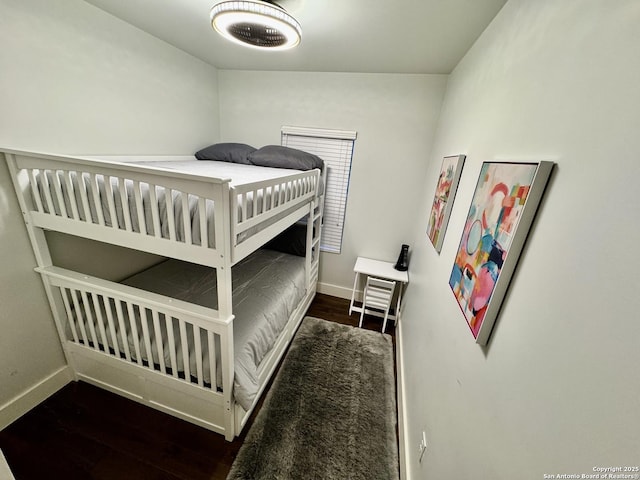 bedroom with dark hardwood / wood-style flooring