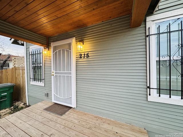 view of exterior entry with a deck