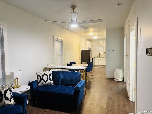 living room with sink, dark hardwood / wood-style floors, and ceiling fan