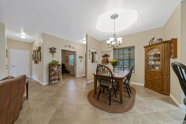 dining room with an inviting chandelier and light tile patterned flooring