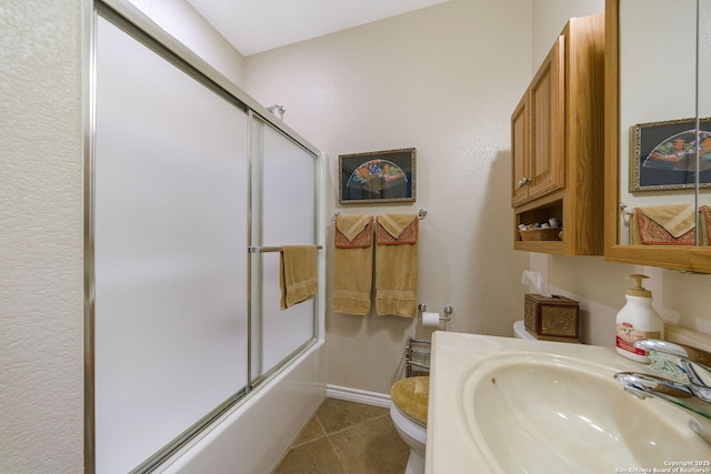 full bathroom featuring tile patterned flooring, sink, shower / bath combination with glass door, and toilet