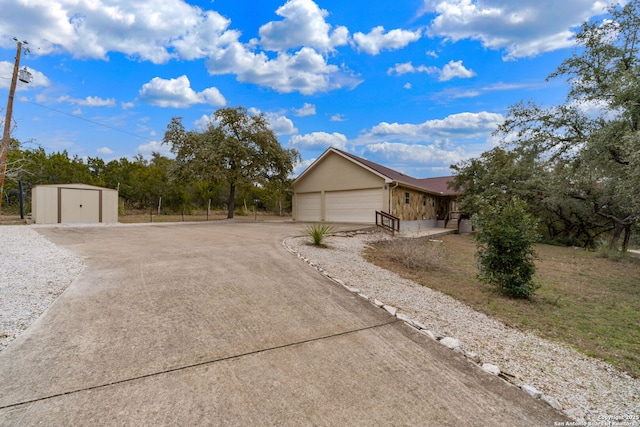 view of property exterior with a garage and a shed