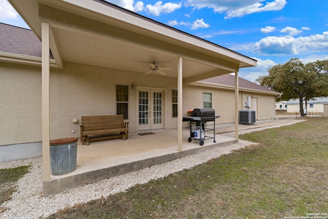 back of house featuring a yard, central AC, ceiling fan, and a patio area