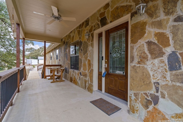 view of exterior entry with ceiling fan