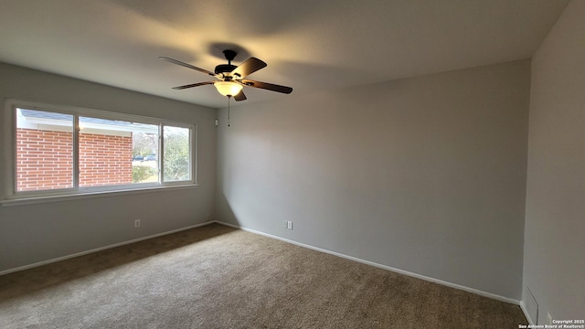 carpeted spare room with ceiling fan