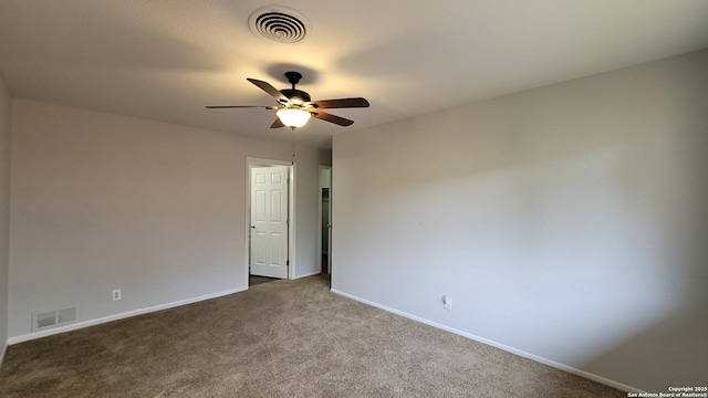 carpeted spare room with ceiling fan