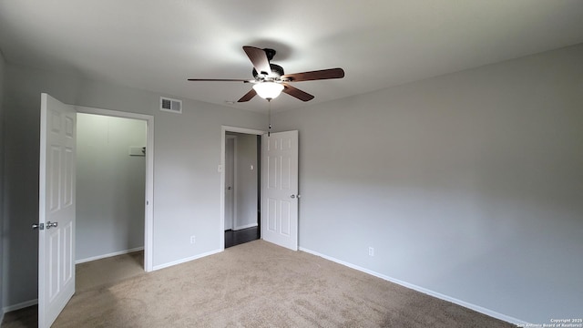 unfurnished bedroom with light colored carpet, ceiling fan, and a closet