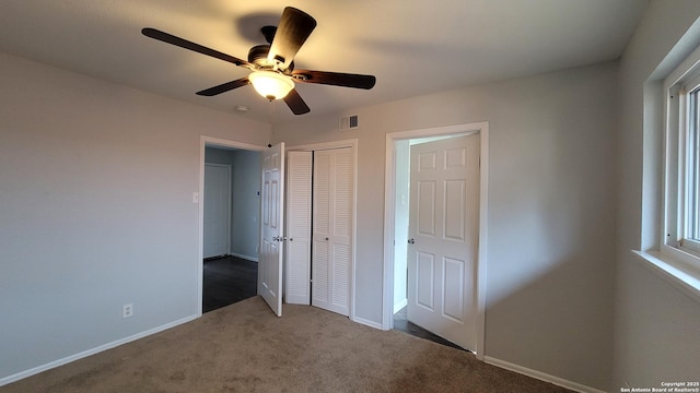 unfurnished bedroom with a closet, ceiling fan, and carpet flooring