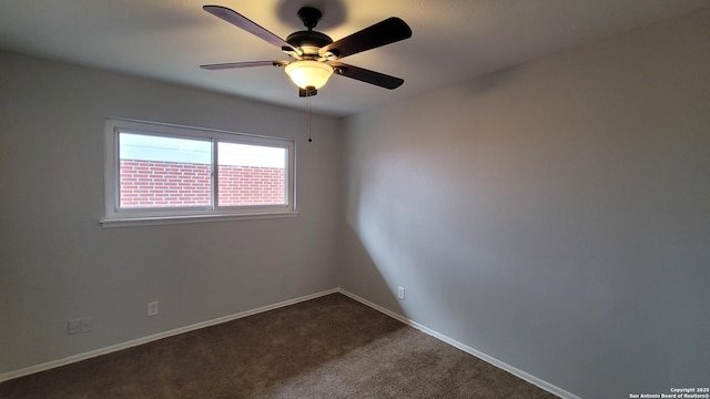 carpeted spare room with ceiling fan