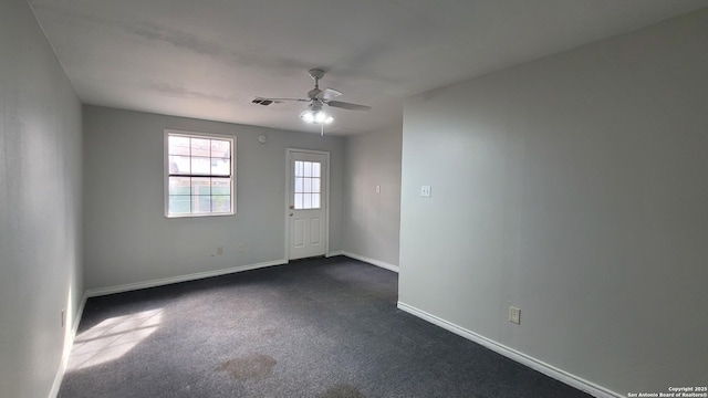 carpeted empty room featuring ceiling fan