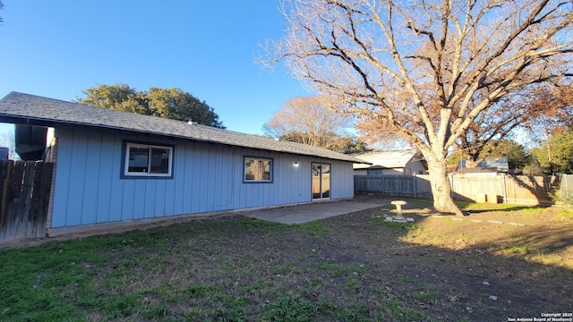 back of property featuring a yard and a patio area