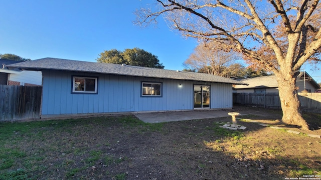 back of house featuring a yard and a patio area