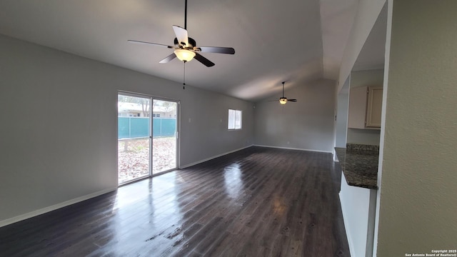 unfurnished living room featuring lofted ceiling, dark hardwood / wood-style floors, and ceiling fan