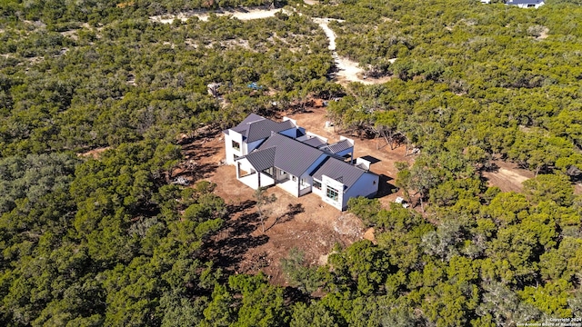 birds eye view of property with a wooded view
