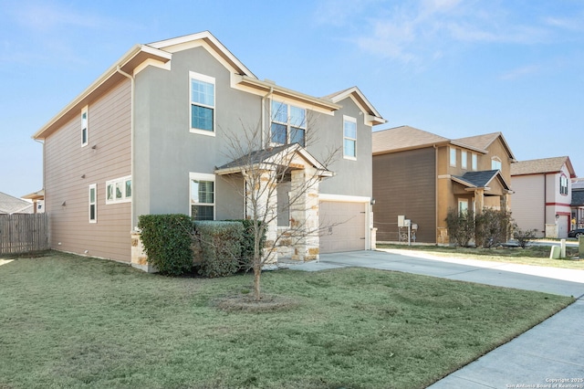 view of front of property with a garage and a front lawn