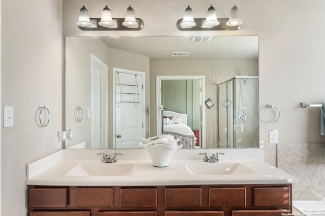 bathroom with an enclosed shower and vanity