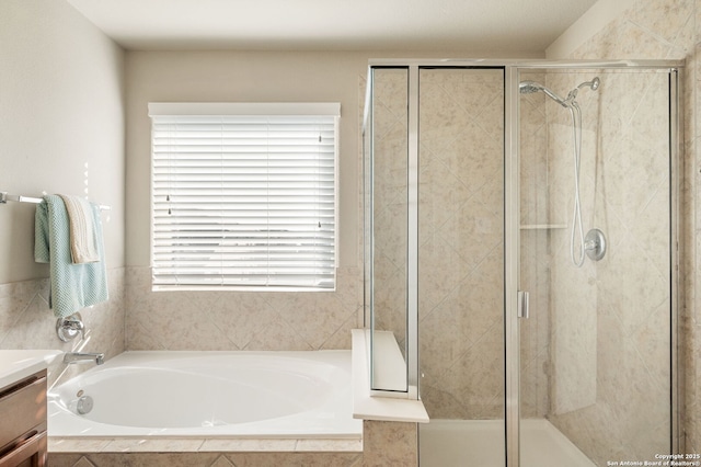 bathroom featuring vanity and shower with separate bathtub