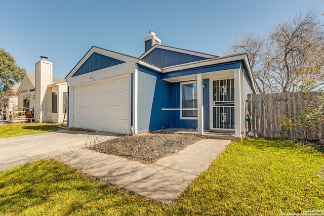 view of front of property featuring a garage and a front yard