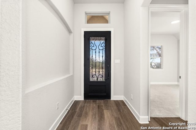 entryway featuring dark wood finished floors and baseboards