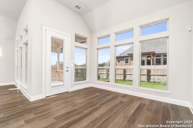 unfurnished sunroom featuring lofted ceiling and visible vents