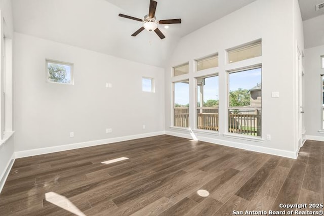 unfurnished room with visible vents, baseboards, a ceiling fan, wood finished floors, and high vaulted ceiling