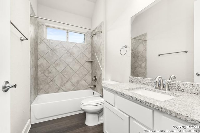 full bath featuring  shower combination, vanity, toilet, and wood finished floors