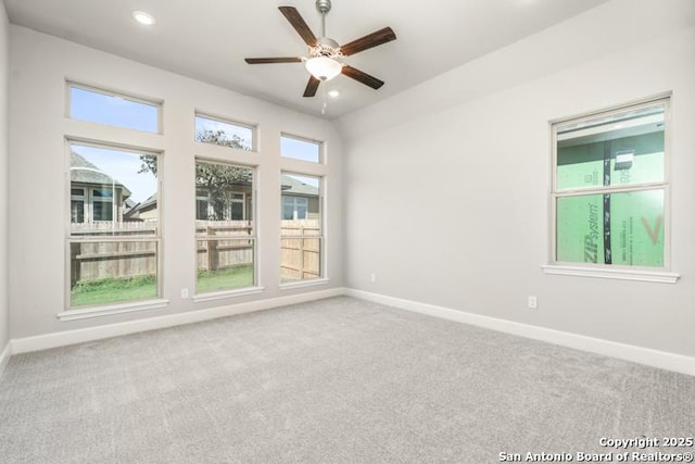 carpeted empty room featuring ceiling fan