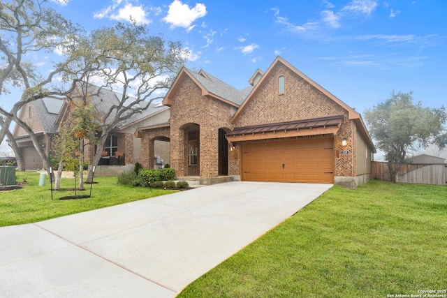 view of front of home featuring a garage and a front yard