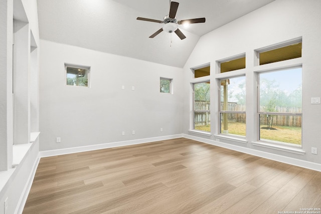 empty room featuring light hardwood / wood-style flooring, high vaulted ceiling, and ceiling fan