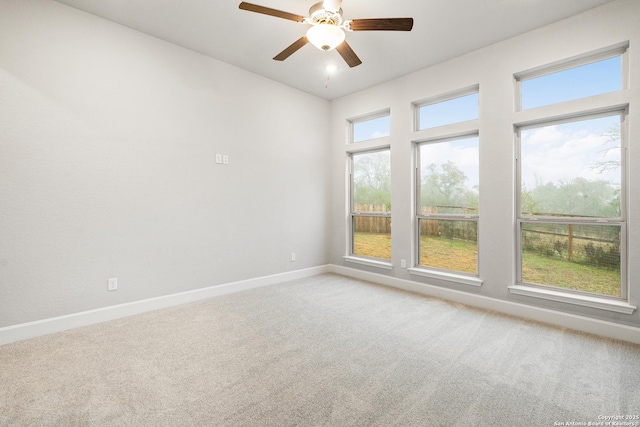 spare room with ceiling fan and carpet