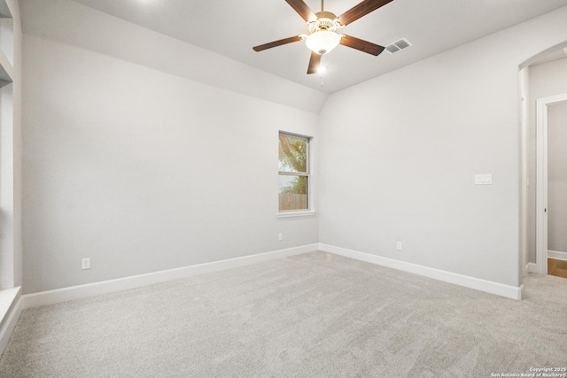 carpeted empty room with lofted ceiling and ceiling fan