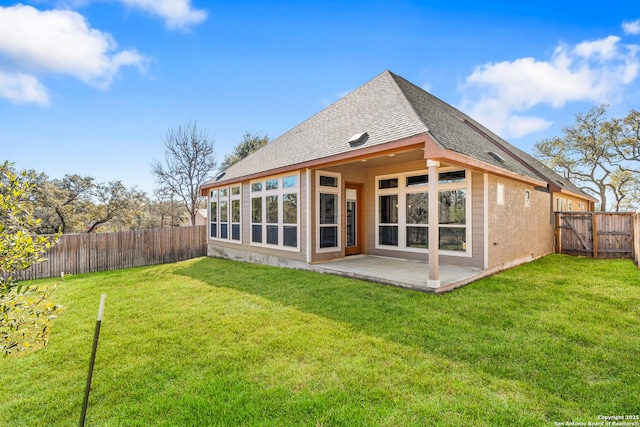 back of property featuring a patio area and a lawn