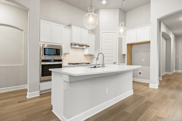 kitchen with white cabinetry, an island with sink, and appliances with stainless steel finishes