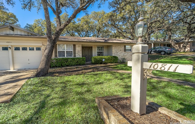 single story home with a garage and a front lawn