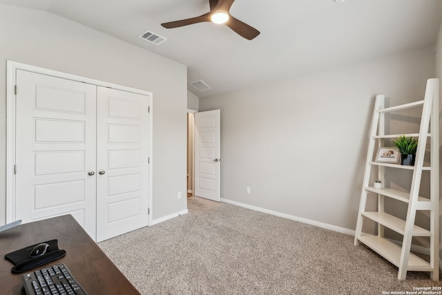 unfurnished bedroom featuring lofted ceiling, a closet, ceiling fan, and carpet flooring